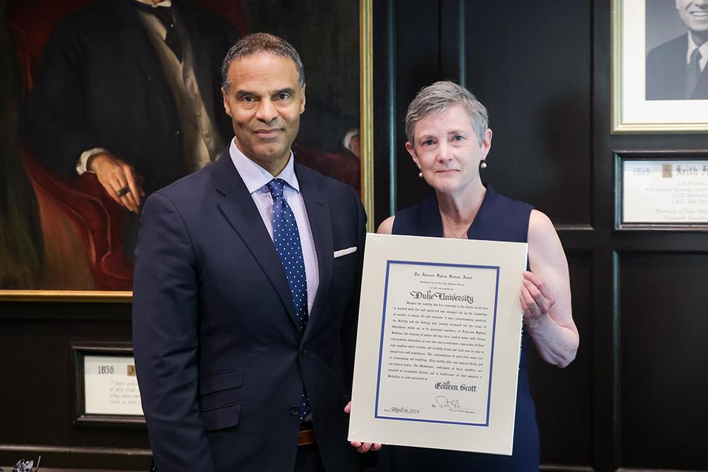 Provost with staff member holding citation