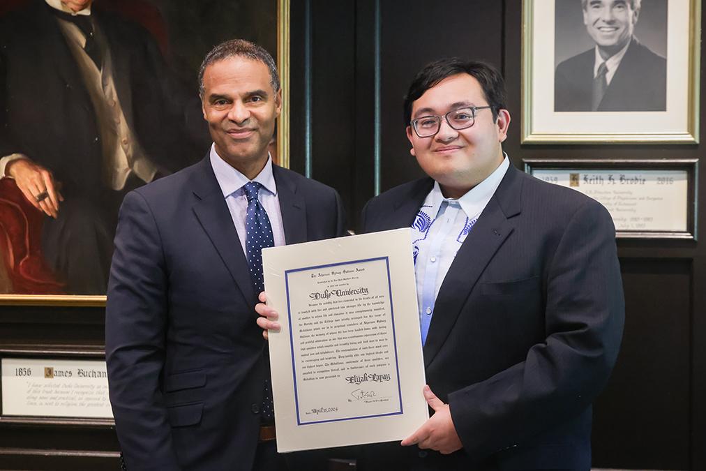 Provost with student holding citation